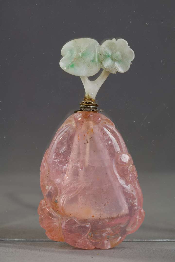 Tourmaline snuff bottle carved in the shape of fruit with foliage and flowers. Jadeite stopper carved in the shape of flowers ...